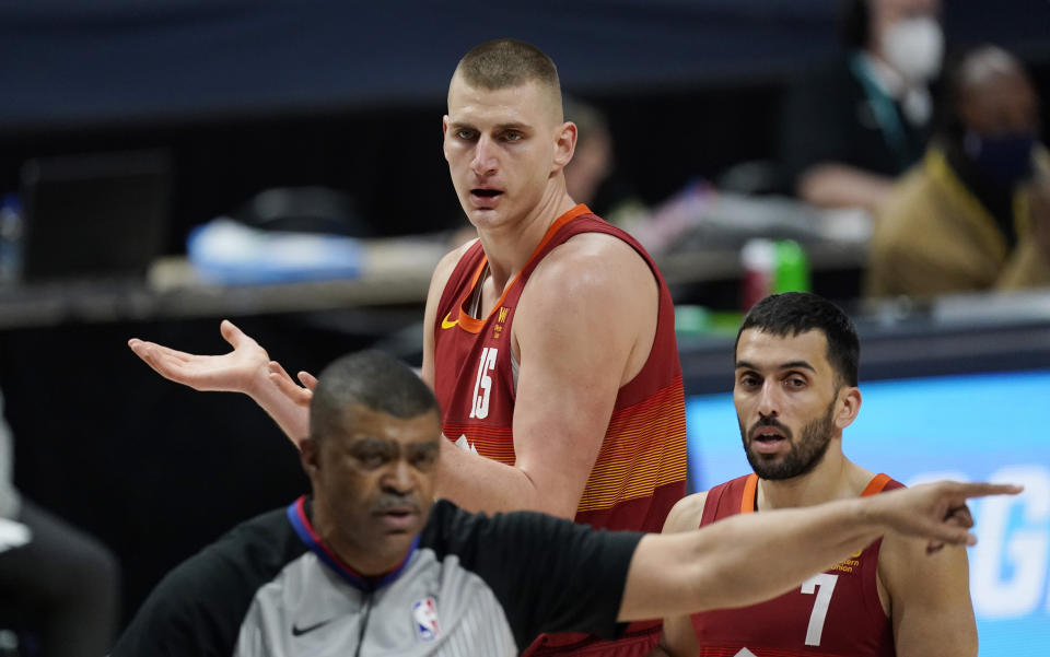 Nikola Jokic argues for a foul as Facundo Campazzo looks on while referee Tony Brothers walks away.