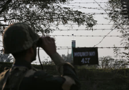 An India's Border Security Force (BSF) soldier keeps vigil during patrol along the fenced border with Pakistan in Ranbir Singh Pura sector near Jammu February 26, 2019. REUTERS/Mukesh Gupta