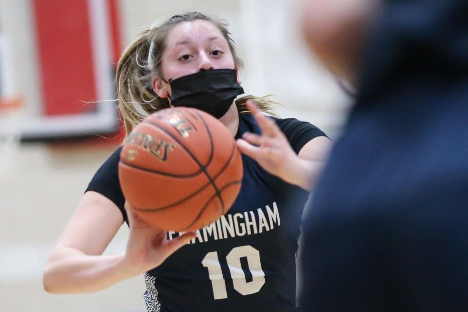 Framingham senior Nicole Moran passes the ball during the girls basketball game against Natick at Natick High School on Dec. 22, 2021.