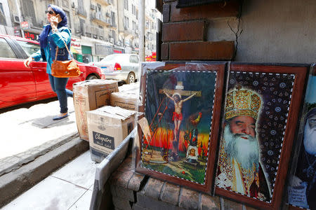 A woman walks past a Christian souvenir shop ahead of Pope Francis’ visit in Cairo, Egypt April 27, 2017. REUTERS/Amr Abdallah Dalsh