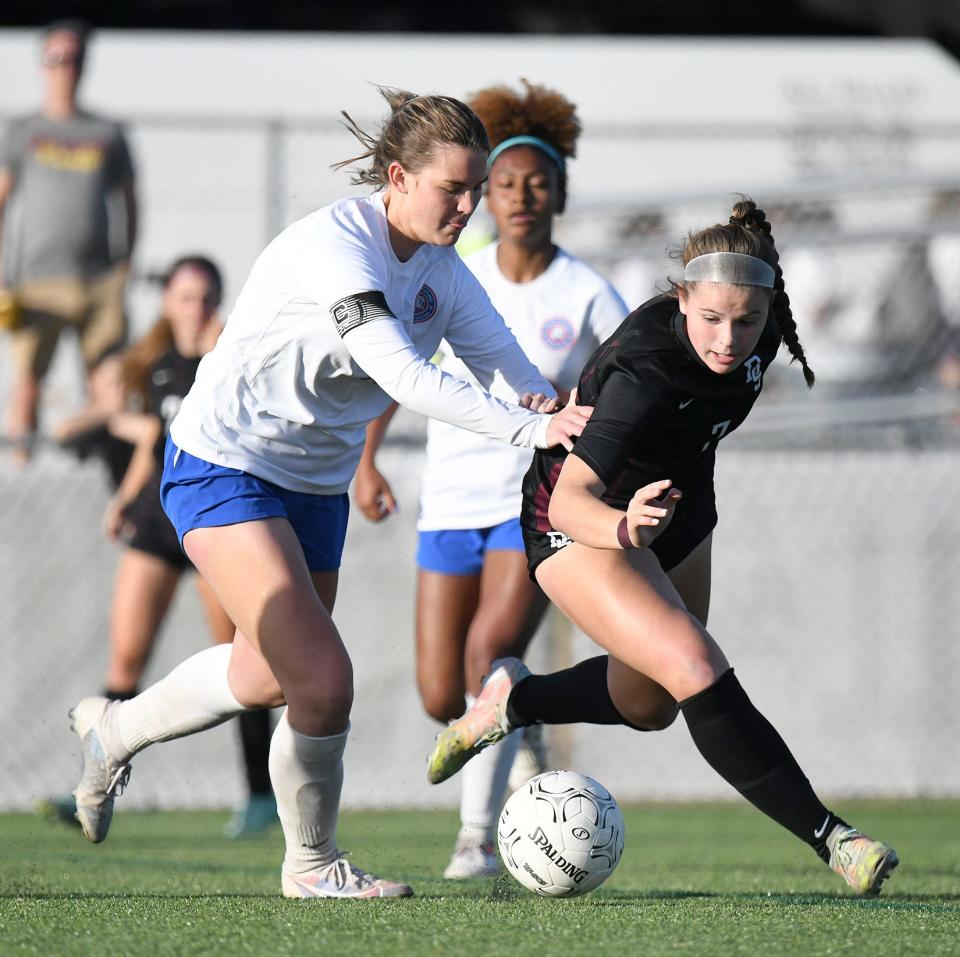 Dripping Spring's Ellie Hodsden brings the ball upfield as Gregory-Portland defender Karlee Friebele gives chase in their Region IV-5A regional semifinal at Cabaniss Soccer Field in Corpus Christi Friday.