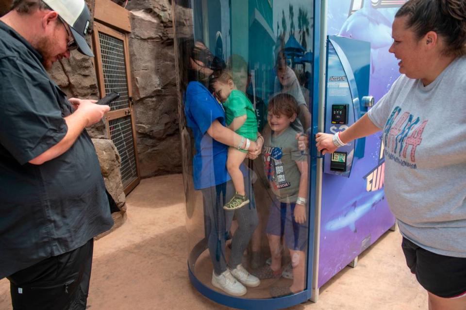 Weston Brown, 6, center right, and his siblings stand in a hurricane simulator at the Mississippi Aquarium in Gulfport on Wednesday, March 20, 2024. Weston, who is in remission from cancer, chose to come to the Mississippi Coast for a trip provided by Make-A-Wish.