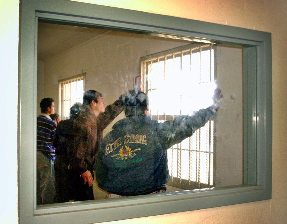 A group of undocumented immigrants whom officials said were caught in the southwestern corner of New Mexico wait in a holding room in Lordsburg, N.M., for transport to El Paso, Texas, on April 3, 2004. Lordsburg agents had apprehended 80 percent more people in the first three months of 2018 than in the same period the previous year. (Photo: Leslie Hoffman/AP)