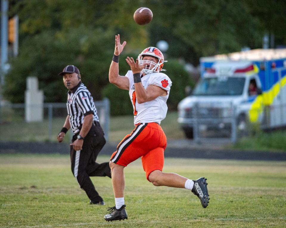 Byron's Brayden Knoll catches a pass on a 50-yard touchdown play in the first quarter of their game at Lutheran on Friday, Sep. 1, 2023.