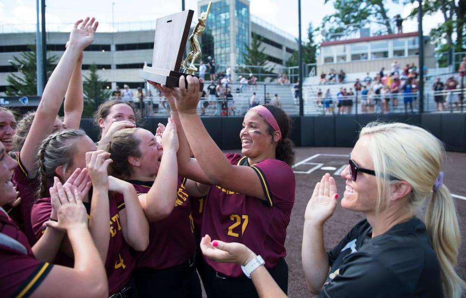 Haddon Heights' Sophia Bordi, center,  hoists the trophy and celebrates with her teammates after Haddon Heights defeated Hanover Park, 4-0, in the Group 2 softball championship game played at Ivy Hill Park in Newark on Saturday, June 4, 2022. 