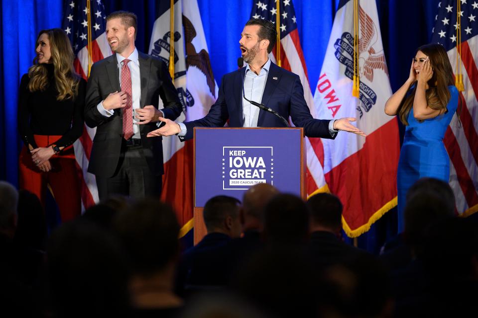 Donald Trump Jr., center, speaks with his brother Eric, second from left, during a "Keep Iowa Great" press conference in Des Moines on Monday. (Jim Watson/AFP via Getty Images)