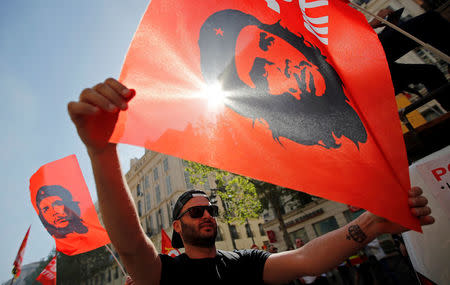 Workers wave CGT labour union flags with an image of revolutionary hero Ernesto "Che" Guevara during a demonstration against the French government's reform plans in Marseille as part of a national day of protest, France, April 19, 2018. REUTERS/Jean-Paul Pelissier