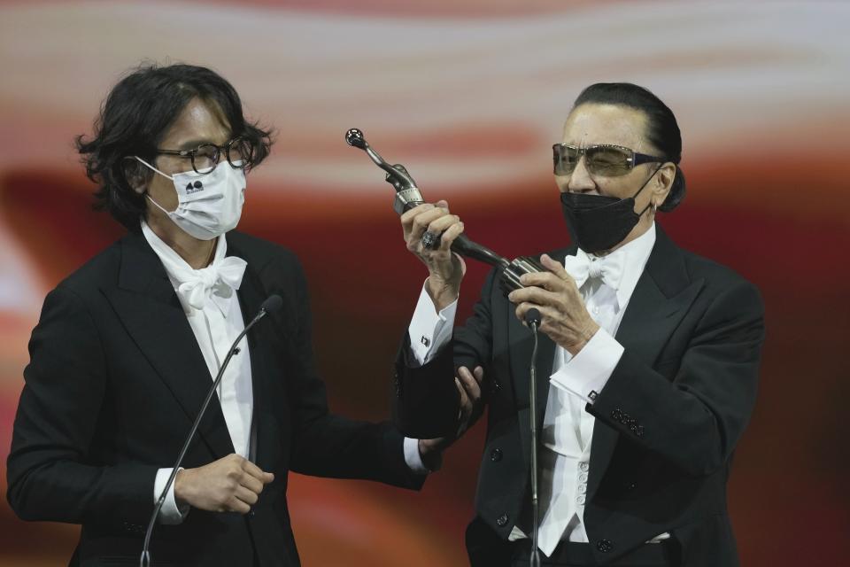 Hong Kong actor Patrick Tse, right, speaks after winning the Best Actor award for the movie "TIME" at the Hong Kong Film Awards, Sunday, July 17, 2022. (AP Photo/Kin Cheung)
