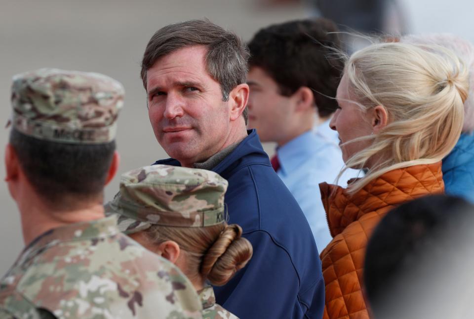 Kentucky Governor Andy Beshear looks back before walking across the tarmac to greet President Joseph R Biden at Fort Campbell Army Airfield in Fort Campbell, KY., on Wednesday, Dec. 15, 2021. 