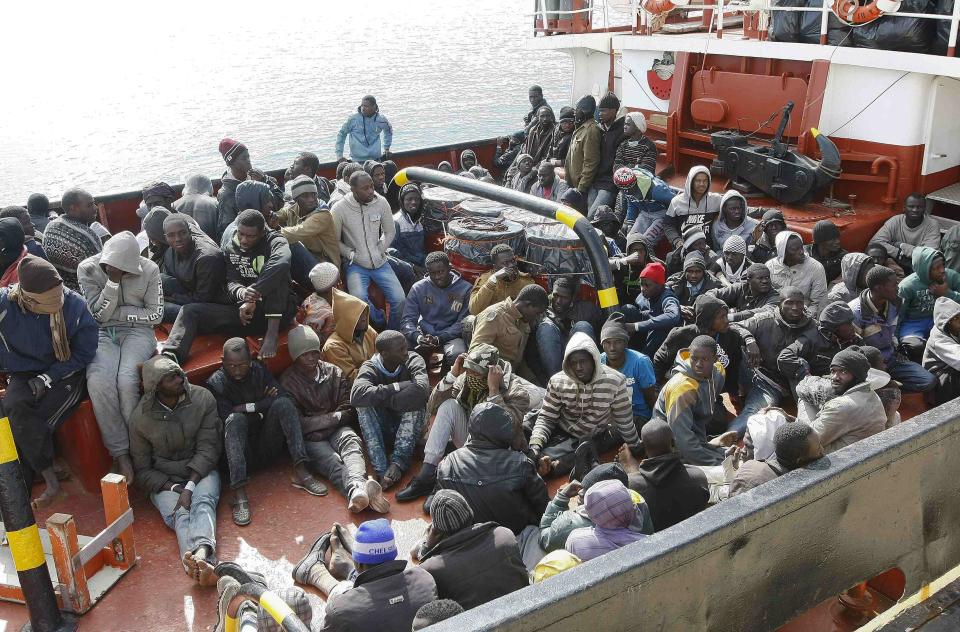 Migrants arrive by boat at the Sicilian harbour of Pozzallo