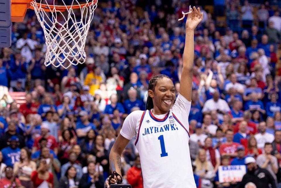 Kansas center Taiyanna Jackson (1) celebrates after cutting a piece of the net after defeating Columbia 66-59 in an NCAA college basketball game in the final of the WNIT, Saturday, April 1, 2023, in Lawrence, Kan.
