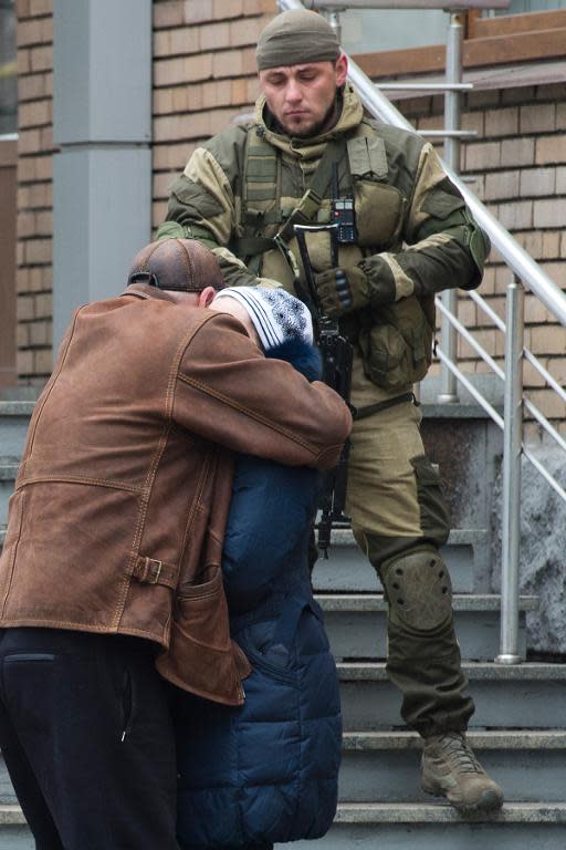 Relatives of miners confort each other outside the Zasyadko mine in Donetsk after a blast occured on March 4, 2015