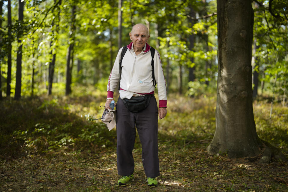 Israeli Olympic racewalker Shaul Ladany poses for a photo after an interview with The Associated Press at the former Nazi concentration camp Bergen-Belsen in Bergen, Germany, Saturday, Sept. 3, 2022. Shaul Ladany survived a Nazi concentration camp and narrowly escaped the massacre of the Israeli athletes at the 1972 Olympic Games in Munich. Both attempts to murder him happened on German soil in the last century. Many decades later, the 86-year-year old Jew has returned to visit the two places where he narrowly escaped death. (AP Photo/Markus Schreiber)