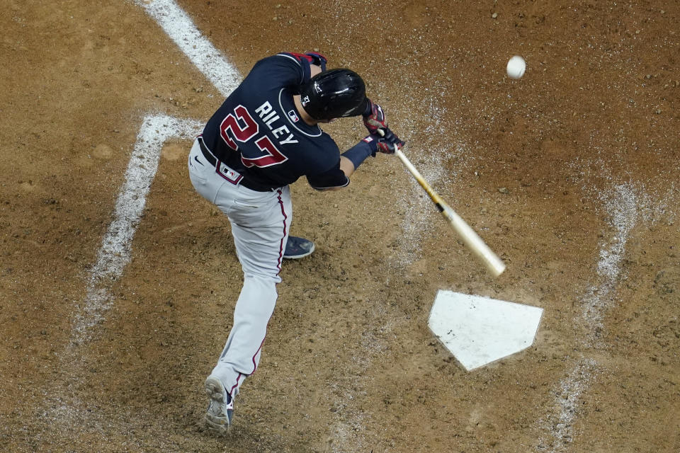 Atlanta Braves' Austin Riley hits a run home against the Los Angeles Dodgers during the ninth inning in Game 1 of a baseball National League Championship Series Monday, Oct. 12, 2020, in Arlington, Texas.(AP Photo/David J. Phillip)