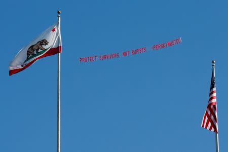 A plane flies over the Stanford stadium trailing a banner calling for the dismissal of the judge in the Stanford rape case prior to the Stanford University commencement ceremony in Palo Alto, California. REUTERS/Elijah Nouvelage