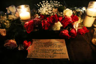 <p>A note is left behind by an attendee on the vigil table during a vigil for the victims of a shooting at Santa Fe High School that left several dead and injured in Santa Fe, Texas, May 18, 2018. (Photo: Pu Ying Huang/Reuters) </p>