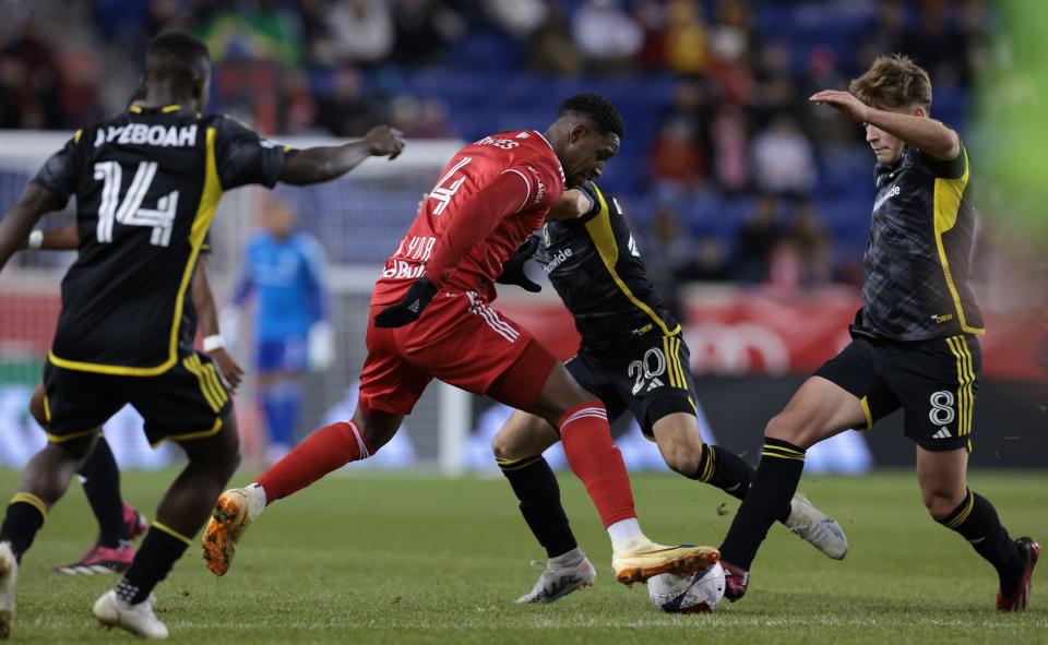 Mar 18, 2023; Harrison, New Jersey, USA; New York Red Bulls defender Andres Reyes (4) fights for the ball against Columbus Crew midfielder Alexandru Matan (20) and Columbus Crew midfielder Aidan Morris (8) at Red Bull Arena. Mandatory Credit: Vincent Carchietta-USA TODAY Sports