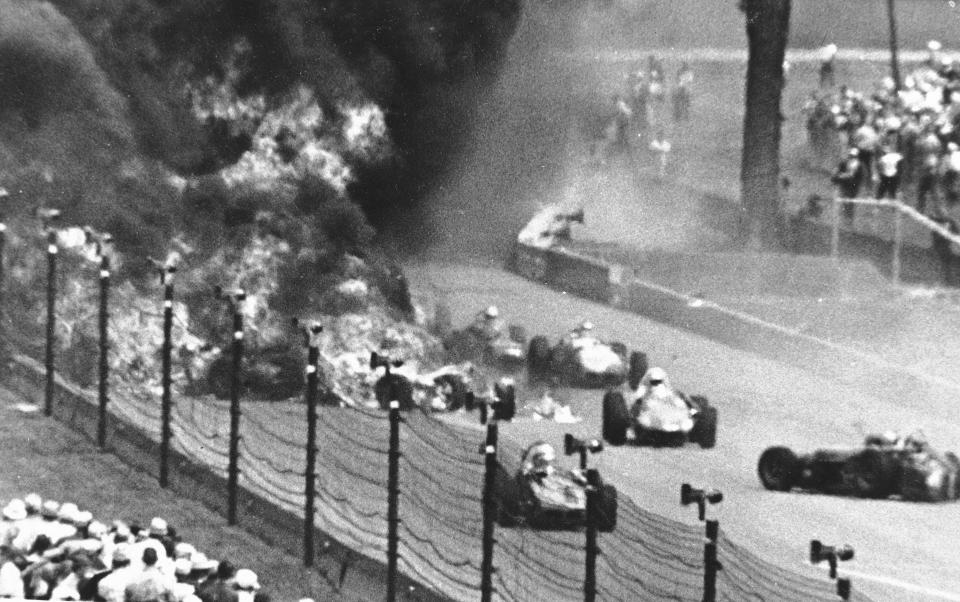 FILE - Drivers weave through blazing wreckage after a crash on the second lap of the Indianapolis 500 auto race at Indianapolis Motor Speedway in Indianapolis on May 30, 1964. Eddie Sachs and Dave MacDonald were killed in the wreckage. The fiery crash that took the lives of Sachs and MacDonald led to more firefighters being hired for races. (AP Photo/File)