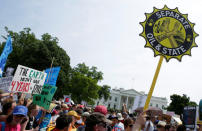 Protesters carry signs during the Peoples Climate March at the White House in Washington, U.S., April 29, 2017. REUTERS/Joshua Roberts