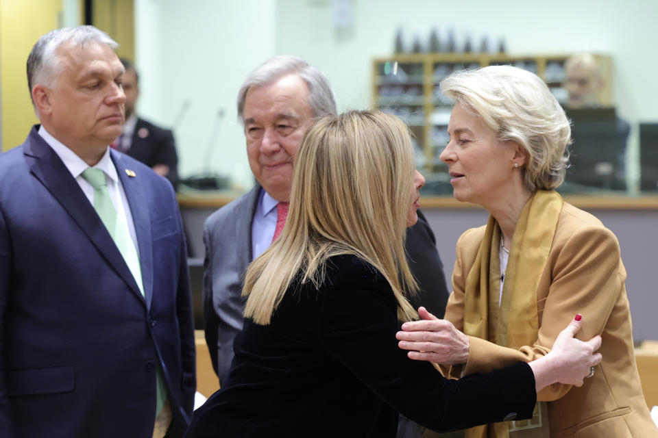 Hungary's Prime Minister Viktor Orban, left, speaks with United Nations High Commissioner for Refugees Antonio Guterres, second left, as European Commission President Ursula von der Leyen, right, greets Italy's Prime Minister Giorgia Meloni during a round table meeting at an EU summit in Brussels, Thursday, March 23, 2023. European Union leaders meet Thursday for a two-day summit to discuss the latest developments in Ukraine, the economy, energy and other topics including migration. (AP Photo/Olivier Matthys)