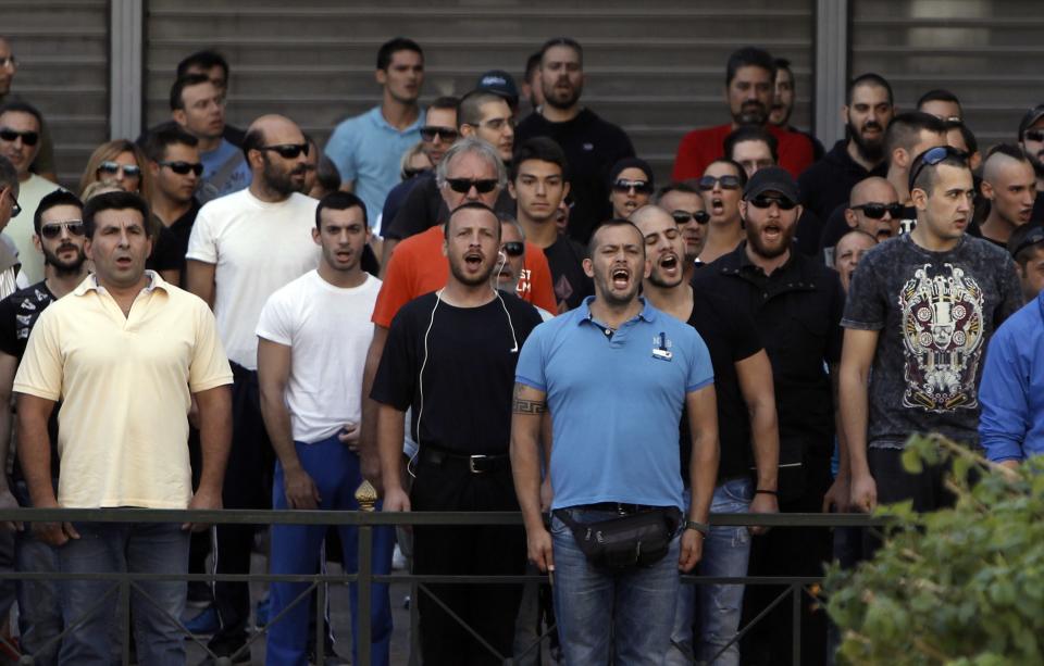 Supporters and members of extreme-right Golden Dawn party shout slogans outside the Greek police headquarters in Athens