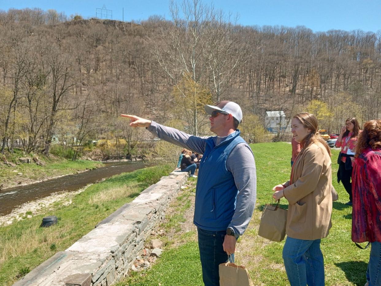 Jayson Wood of Woodland Design Associates points out features of the Sycamore Point project under development to a group from Wayne Tomorrow on April 26, 2024. The county commissioners obtained grant funding to create a river-facing public park at the former Industrial Point, at the end of 12th Street where the Lackawaxen River bends.