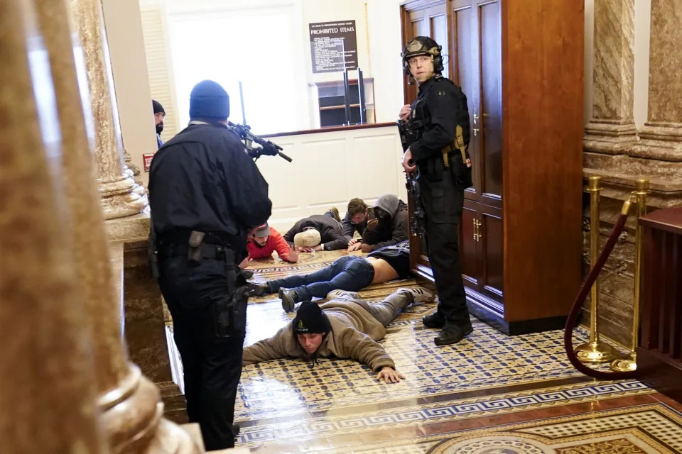 FILE - U.S. Capitol Police hold rioters at gun-point near the House Chamber inside the U.S. Capitol on Jan. 6, 2021, in Washington. (AP Photo/Andrew Harnik, File)