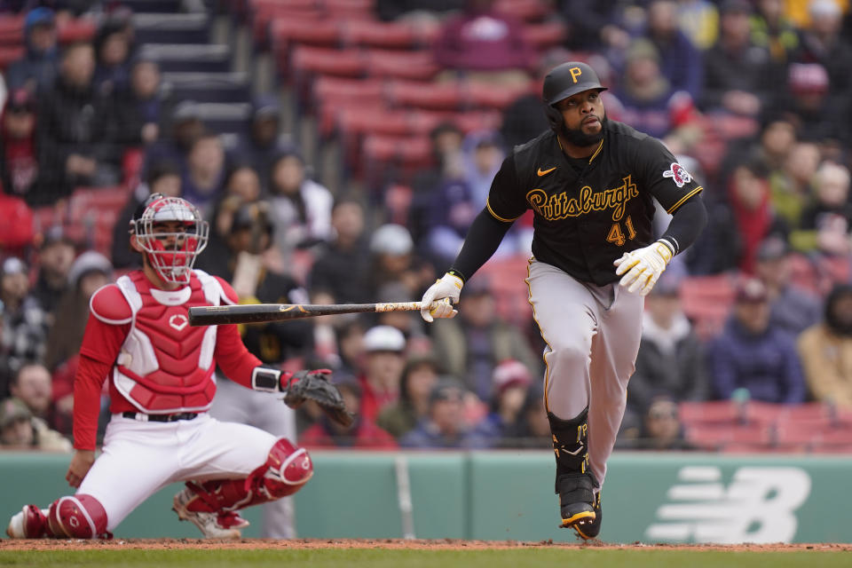 Pittsburgh Pirates' Carlos Santana, right, watches the fight of his home run in front of Boston Red Sox's Connor Wong in the fourth inning of a baseball game, Wednesday, April 5, 2023, in Boston. (AP Photo/Steven Senne)