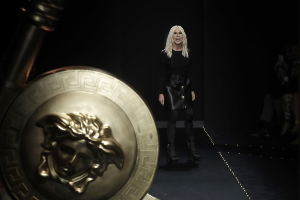 Designer Donatella Versace accepts applause at the end of the Versace women's Fall-Winter 2019-2020 collection, that was presented in Milan, Italy, Friday, Feb. 22, 2019. (AP Photo/Luca Bruno)
