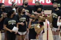 Stanford guard Anna Wilson, foreground, gestures in front of teammates as she and other senior players are honored after Stanford defeated California in an NCAA college basketball game in Stanford, Calif., Sunday, Feb. 28, 2021. (AP Photo/Jeff Chiu)