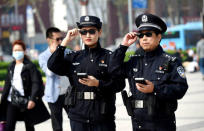 FILE PHOTO: Police officers display their AI-powered smart glasses in Luoyang, Henan province, China April 3, 2018. REUTERS/Stringer/File Photo