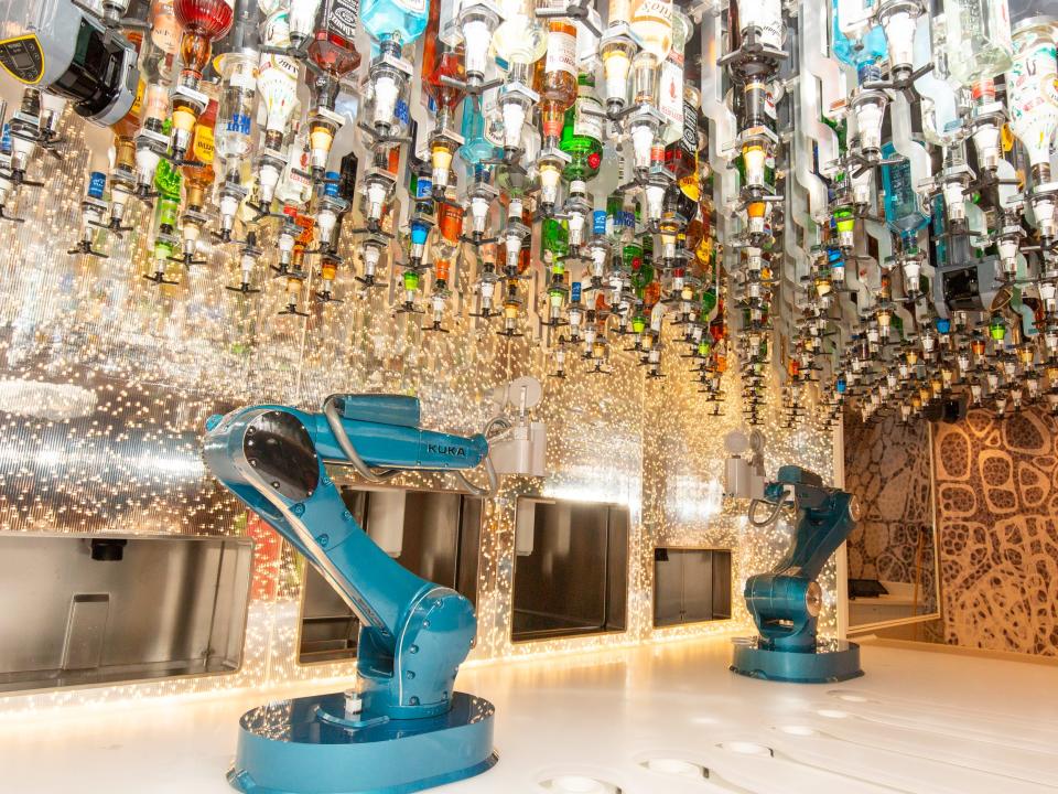 robot bartender arms under bottles of liquor on Royal Caribbean Wonder of the Seas