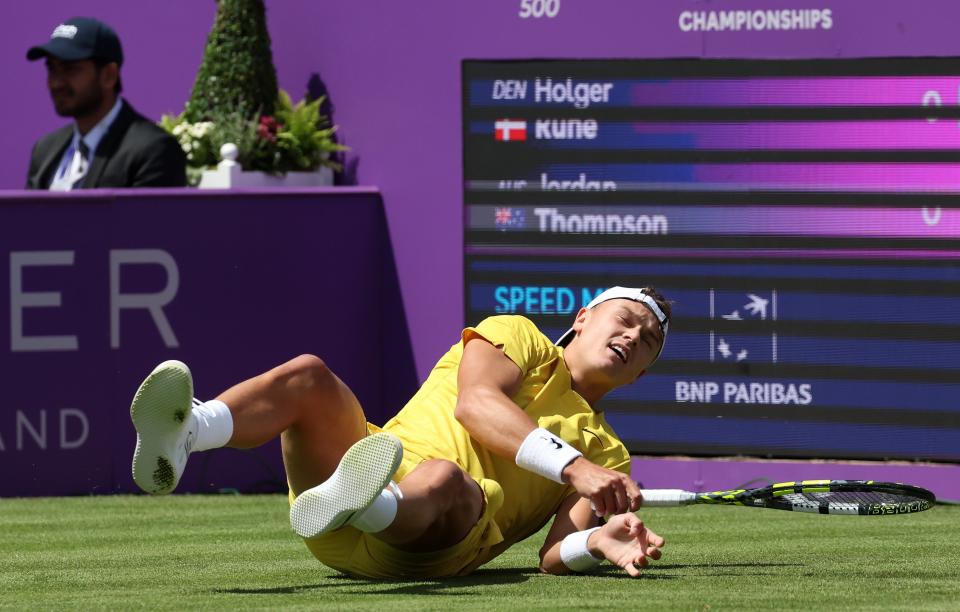 Holger Rune slips to the ground during his first-round defeat (EPA)