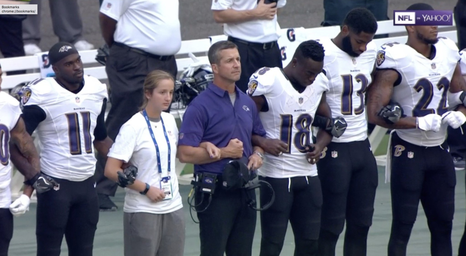 John Harbaugh stands with his players. (Via Yahoo screenshot)