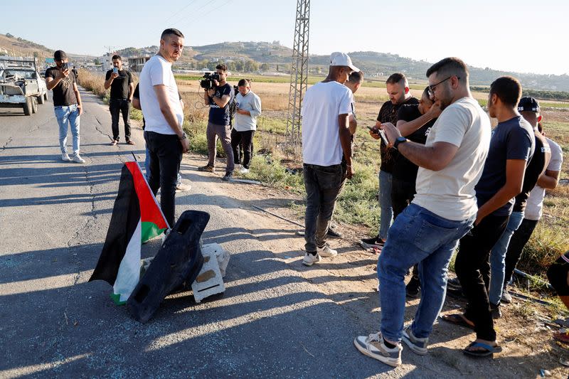 Palestinians gather at the scene where Israeli forces targeted a Palestinian car, near Jenin