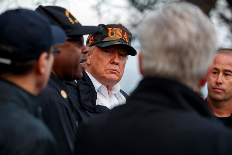 Mr Trump visits a neighbourbood affected by the Woolsey Fire (AP)