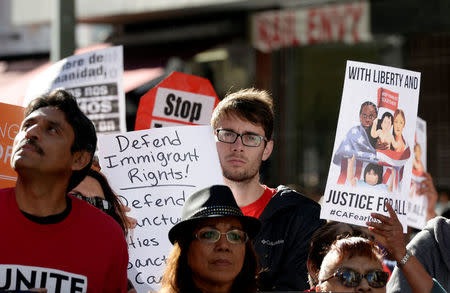 Protesters hold up signs during a march and rally against the United States President-elect Donald Trump in Los Angeles, California, U.S. December 18, 2016.REUTERS/Kevork Djansezian