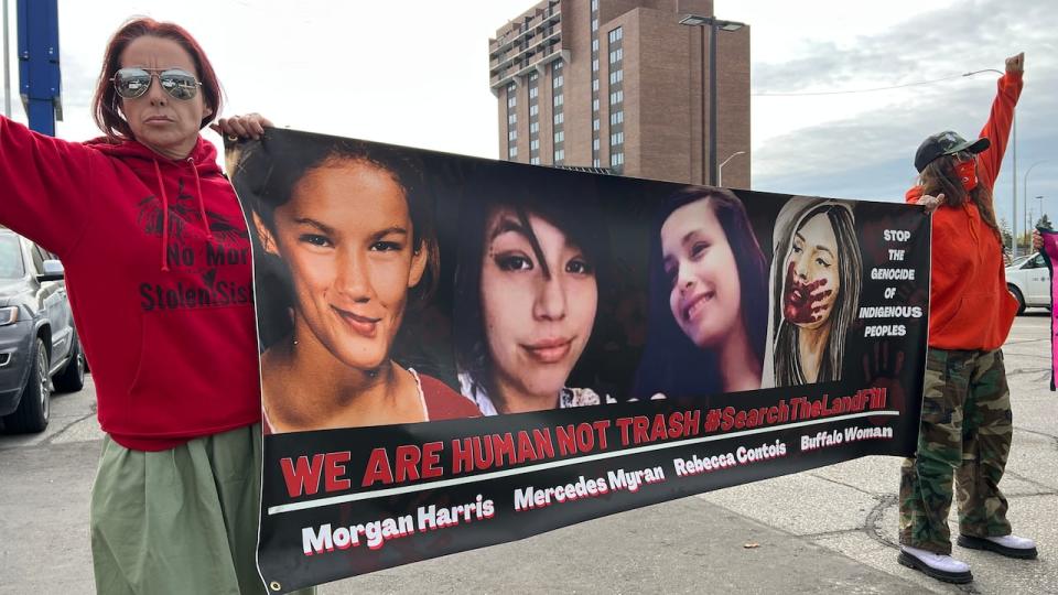 Protestors calling for a search of the Prairie Green landfill for the remains of murdered Indigenous women gathering outside a PC campaign announcement in Winnipeg's Kirkfield Park riding Wednesday. 