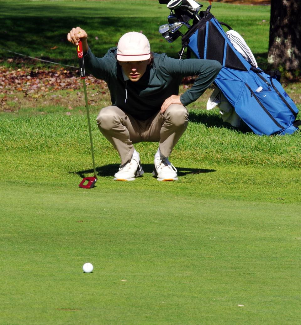 Owen Hamilton of Duxbury decides the line he wants to use on his putt at the 12th green during Div. 2 MIAA Tourney golf play at the Easton Country Club on Tuesday, Oct. 24, 2023.