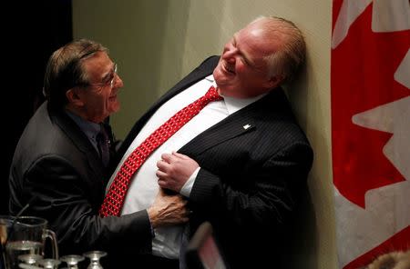 Toronto's Chief Budget Officer Councillor Frank Di Giorgio (L) shares a moment with Toronto Mayor Rob Ford during a budget meeting at City Hall in Toronto, January 30, 2014. REUTERS/Aaron Harris