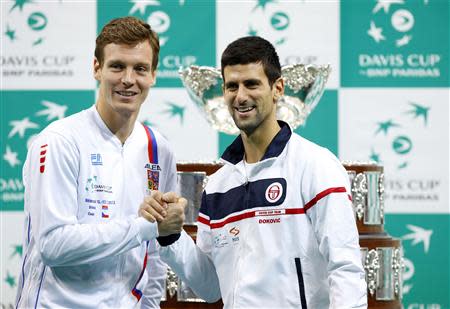 Serbian tennis team player Novak Djokovic (R) and Czech tennis team player Tomas Berdych shake hands after the official draw for the Davis Cup finals at Belgrade Arena in Belgrade November 14, 2013. REUTERS/Marko Djurica