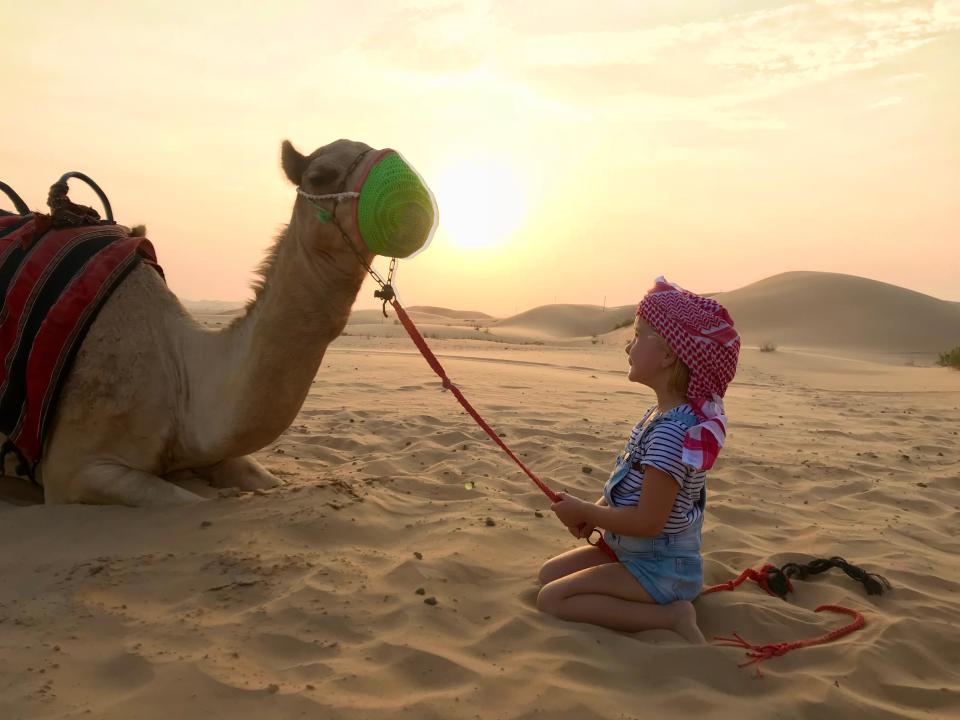 Karen Edwards' child and a camel in the Middle East.