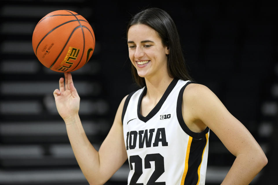 Iowa guard Caitlin Clark poses for photographers during Iowa's NCAA college basketball media day, Wednesday, Oct. 4, 2023, in Iowa City, Iowa. (AP Photo/Charlie Neibergall)