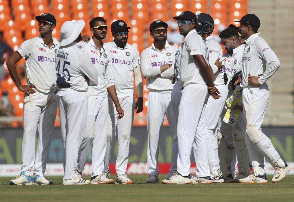 Indian players await third umpire's decision for the wicket of England's Dom Bess during the first day of fourth cricket test match between India and England at Narendra Modi Stadium in Ahmedabad, India, Thursday, March 4, 2021. (AP Photo/Aijaz Rahi)