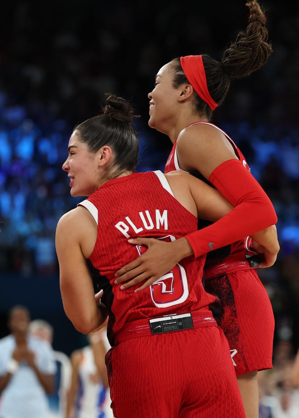 PARIS, FRANCE - AUGUST 11: Napheesa Collier #11 and Kelsey Plum #5 of Team United States celebrate after their team's victory against Team France during the Women's Gold Medal game between Team France and Team United States on day sixteen of the Olympic Games Paris 2024 at Bercy Arena on August 11, 2024 in Paris, France. (Photo by Gregory Shamus/Getty Images) ORG XMIT: 776138675 ORIG FILE ID: 2166338290