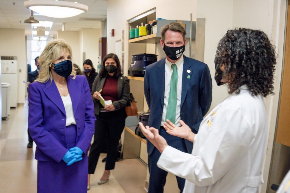 National Cancer Institute Director Ned Sharpless  and first lady Jill Biden are briefed by a research staff member at the Massey Cancer Center in Richmond, Va., on Feb. 24.