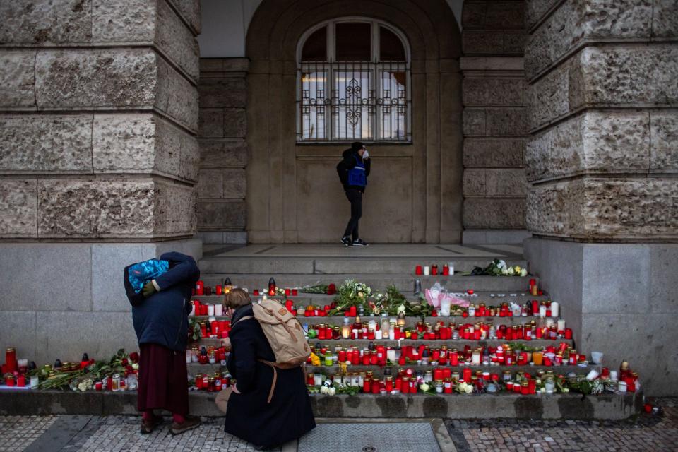 People pay respects outside the Philosophical Faculty of Charles University following a mass shooting, during the day of national mourning in central Prague, Czech Republic, on Saturday (EPA)