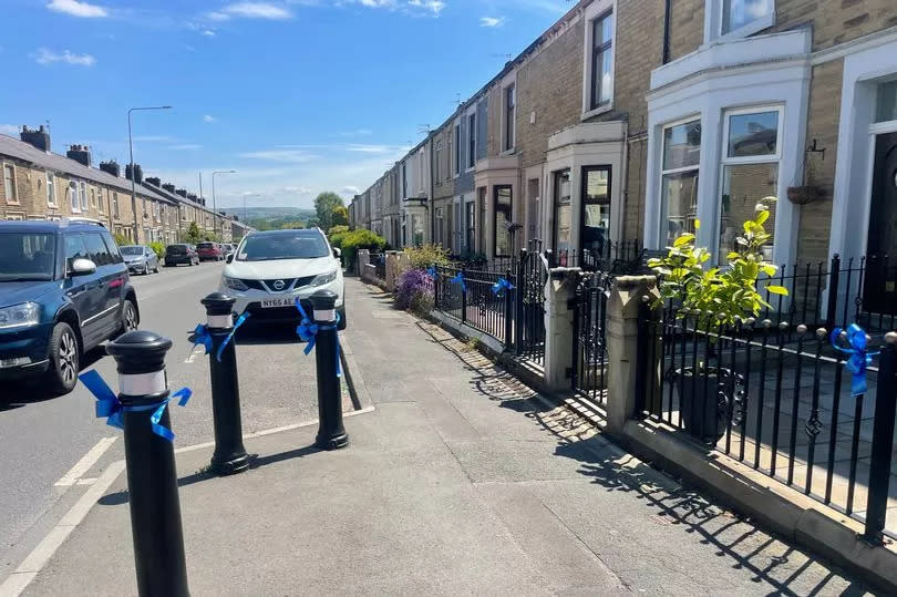 Oswaldtwistle has turned blue with ribbons to show support for Jay Slater