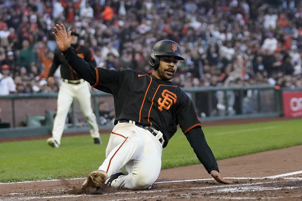 San Francisco Giants' LaMonte Wade Jr. slides home to score against the Baltimore Orioles during the third inning of a baseball game in San Francisco, Saturday, June 3, 2023. (AP Photo/Jeff Chiu)