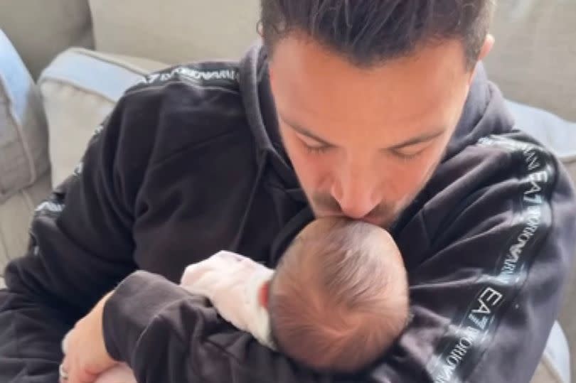 Peter Andre plants a kiss on his little one's head